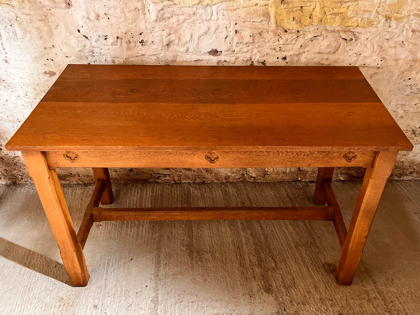 Wooden table against a textured stone wall