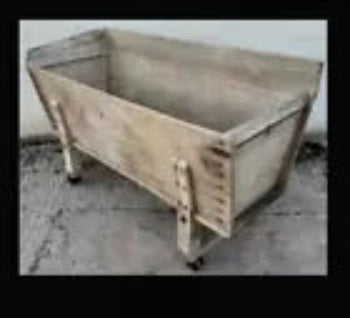 A 19th century bakers dough bin with original cast iron wheels