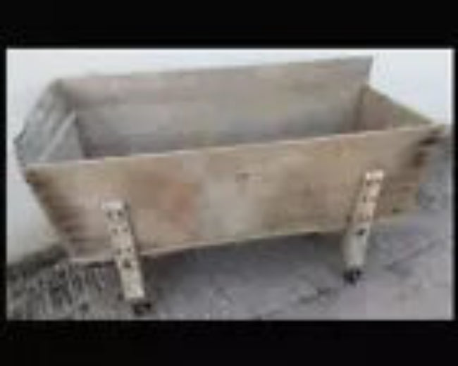 A 19th century bakers dough bin with original cast iron wheels