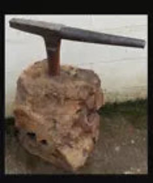 Antique Tinsmiths stake anvil leaded into a large section of tree trunk quirky coffee table idea