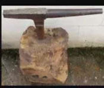 Antique Tinsmiths stake anvil leaded into a large section of tree trunk quirky coffee table idea