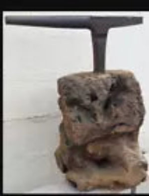 Antique Tinsmiths stake anvil leaded into a large section of tree trunk quirky coffee table idea