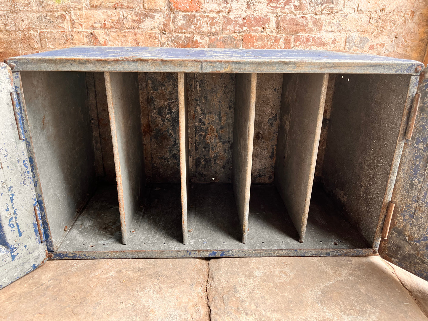 Industrial style metal cabinet with aged blue paint