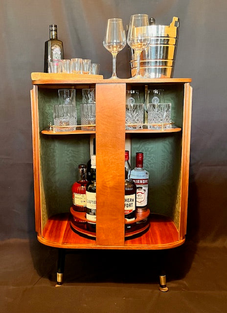Mid Century Bow Fronted 'Sureline' Cocktail Drinks Cabinet In Walnut By George Serlin With Tambour Sliding Doors On Splayed Atomic Legs