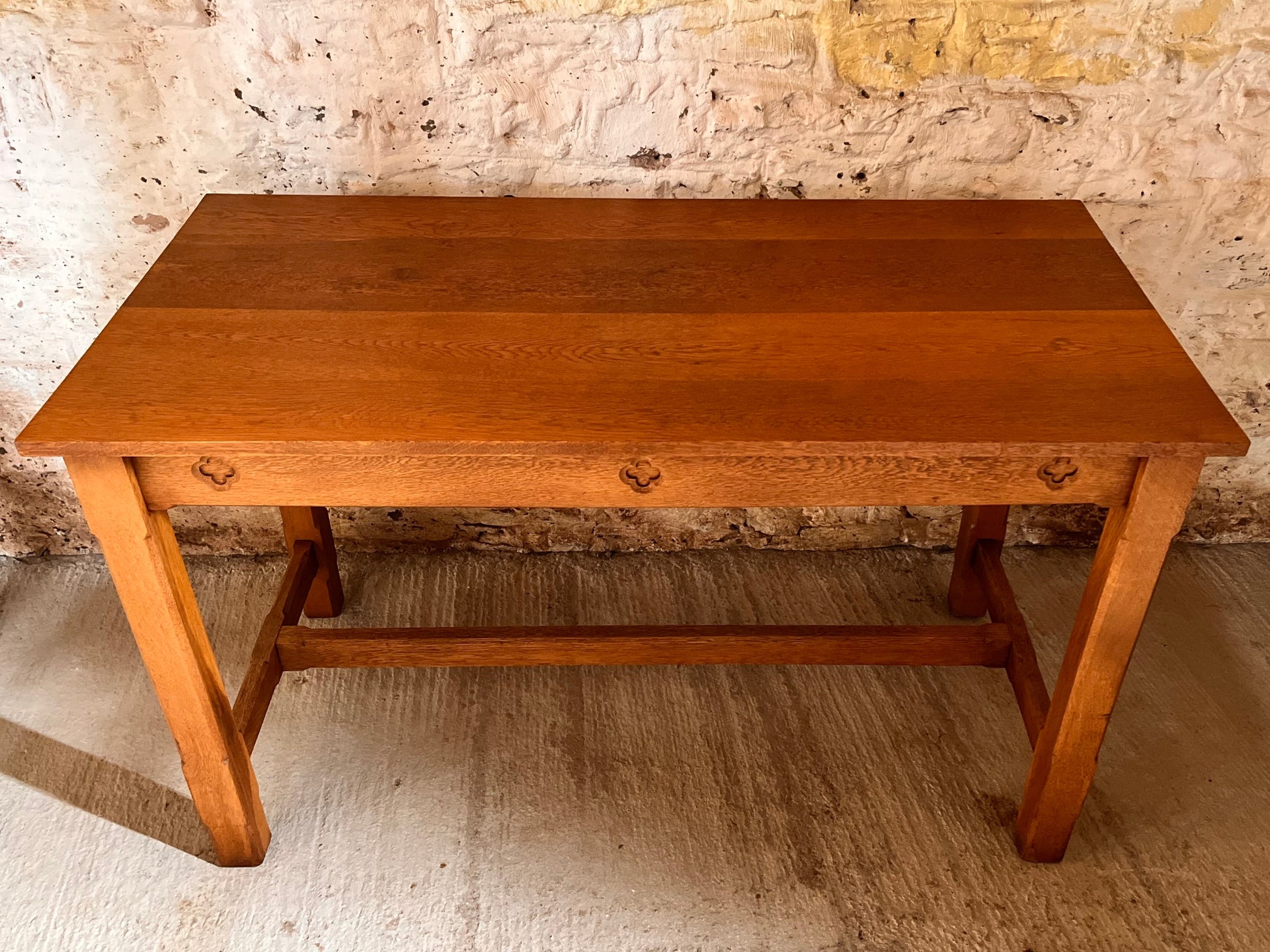 Wooden table against a textured stone wall