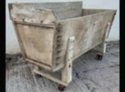 A 19th century bakers dough bin with original cast iron wheels